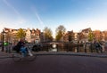 Amsterdam people riding bicycles in historical part in Amsterdam, Netherlands Royalty Free Stock Photo