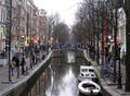 Amsterdam`s illuminated canal at dusk