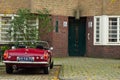 Amsterdam School entrance with vintage MG car