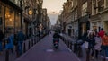 Amsterdam streets with people walking and men in bike