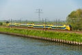 Dutch railway train alongside the Amsterdam-Rhine Canal
