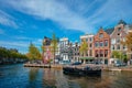 Amsterdam view - canal with boad, bridge and old houses Royalty Free Stock Photo