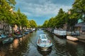 Amsterdam view - canal with boad, bridge and old houses Royalty Free Stock Photo