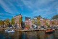 Amsterdam view - canal with boad, bridge and old houses