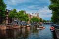 Amsterdam view - canal with boad, bridge and old houses Royalty Free Stock Photo