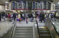 Amtrak train travelers stand in line under Departures sign, while a man goes down escalator at Penn Station, New York City Royalty Free Stock Photo