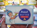 Amul Butter Unsalted holding in hands sky-blue color packaging in amul dairy productsstore