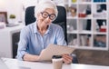 Amused aged woman working in the office Royalty Free Stock Photo