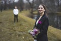 Amused beautiful Turkish bride looking at camera with a big smile on her face in black suit jacket that belongs to her Royalty Free Stock Photo