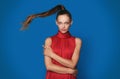 Amused beautiful young woman in red dress