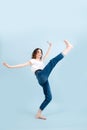 Amused contemporary dancer rising her leg up, tilting back, loosing her balance. Royalty Free Stock Photo