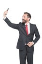 Amused elegant businessman making selfie