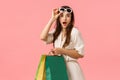Amused feminine girl, waisting all money on new clothes, found favorite store, holding shopping bags and gazing camera Royalty Free Stock Photo