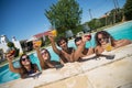 Amused friends resting at poolside