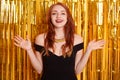 Amused happy gorgeous red haired female in cute black dress, spread hands welcoming sideways and smiling amazed, greeting friend, Royalty Free Stock Photo