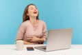 Amused happy woman employee laughing out loud, holding her stomach and being hysterical at crazy joke