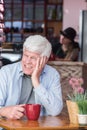 Amused Mature Man in Coffee House