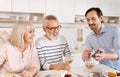 Amused mature man enjoying family weekend at home