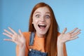 Amused speechless surprised astonished redhead girl hear exciting positive news smiling gladly wide eyes thrilled raised Royalty Free Stock Photo