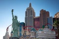 an amusement area with the statue of liberty in the background