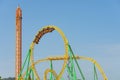 Amusement cart makes circular rides on a dead loop upside down at motion blur effect high speed, roller coaster yellow-green color Royalty Free Stock Photo