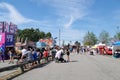 amusement park adults and children stroll against backdrop of swing. people have fun on summer autumn day. teenagers buy