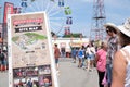 amusement park adults and children stroll against backdrop of swing. people have fun on summer autumn day. teenagers buy