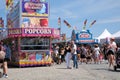 amusement park adults and children stroll against backdrop of swing. people have fun on summer autumn day. teenagers buy