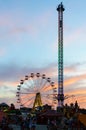 Amusement park on the background of the sunset. Ferris wheel