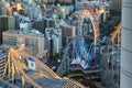 Amusement park in the center of Tokyo. Roller coaster intertwining with skyscrapers