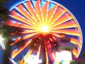 Amusement park Ferris wheel with blurred multicolored lights