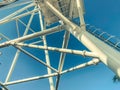 Amusement park. ferris wheel made of white metal. on the wheel are large cabins for skiing tourists. huge structure made of metal Royalty Free Stock Photo