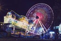 Amusement park with ferris wheel at night with lights long exposure Royalty Free Stock Photo