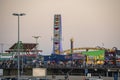 Amusement park with ferris wheel and rollercoaster at Santa Monica pier beach