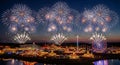 Amusement park fireworks celebration at night with reflections Royalty Free Stock Photo