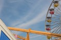 Amusement park rides in bright colors against a blue sky