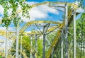 Amusement Park roller coaster ride, against the background of trees and blue sky in bright sunlight, no one Royalty Free Stock Photo