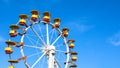 Amusement park wheel in a cloudless sunny day Royalty Free Stock Photo