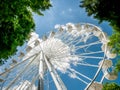 Amusement ride against blue sky. Close up with a white ferrys wheel Royalty Free Stock Photo