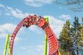 Amusement trolley makes circle loop turns upside down, roller coaster. Frightened faces of people repenting on carts. Russia.