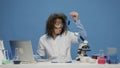 Amusing crazy chemist analyzing liquid in test tube at desk