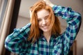 Amusing funny girl in checkered shirt with tousled red hair Royalty Free Stock Photo