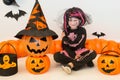 Pretty little girl dressing up as a witch in a Halloween setting Royalty Free Stock Photo