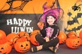 Pretty little girl dressing up as a witch in a Halloween setting Royalty Free Stock Photo