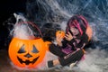 Pretty little girl dressing up as a witch in a Halloween setting Royalty Free Stock Photo