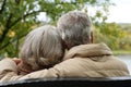 Amusing senior couple sitting on bench in park Royalty Free Stock Photo