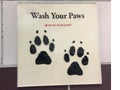 A amusing sign telling people to wash their paws