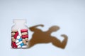 Anabolic, sports dope in bank and the image of a bodybuilder in the form of a shadow. Medical concept of abuse of doping