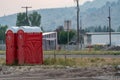 Two portable bathrooms portapotties outdoors, at a construction site