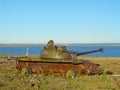Debris of ancient Soviet battle tank corroding outdoors on scrap metal storehouse on scenic natural landscape background. Symbol o